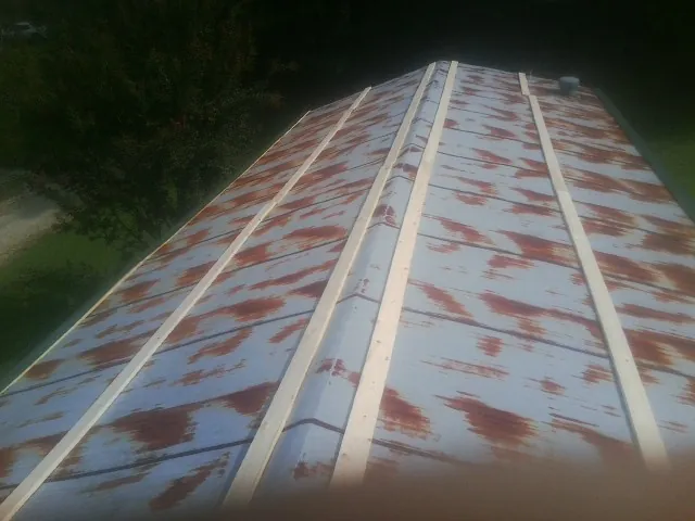 Rusted metal roof panels with new wood purlins before replacement — Storm Damage Roof Repair in Shamokin by Roofing Brothers