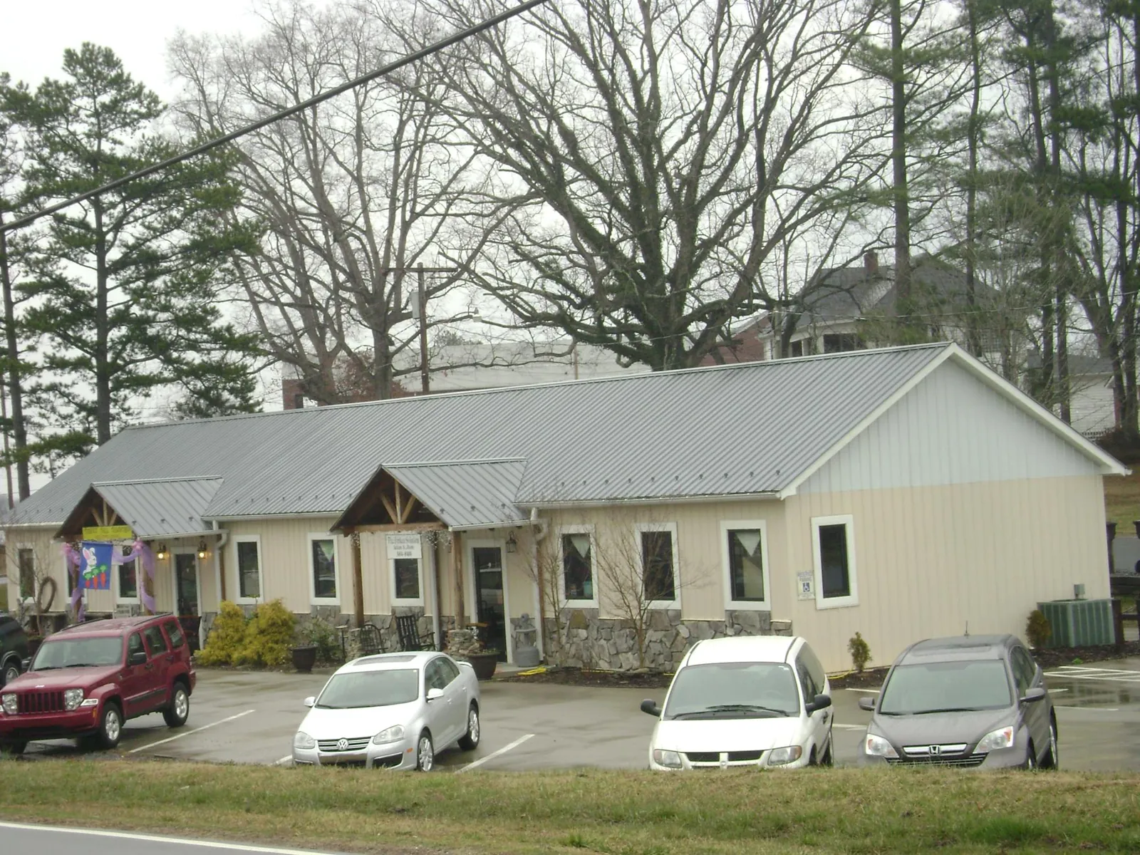 Gray metal roof with timber entry brackets on a small commercial building in Shamokin