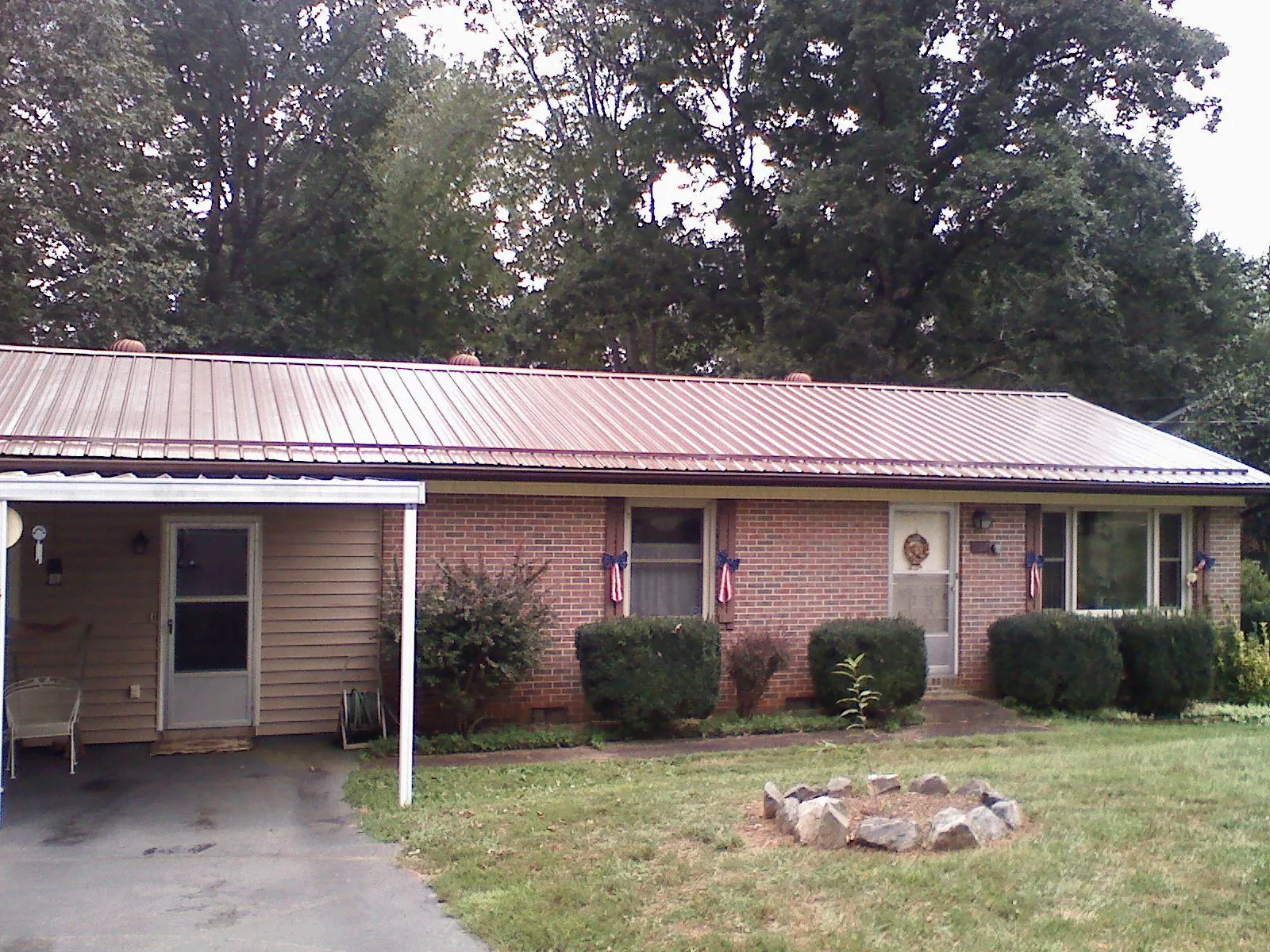 Bronze metal roof and carport on a brick ranch home — Roof Repair work by our crew in Shamokin