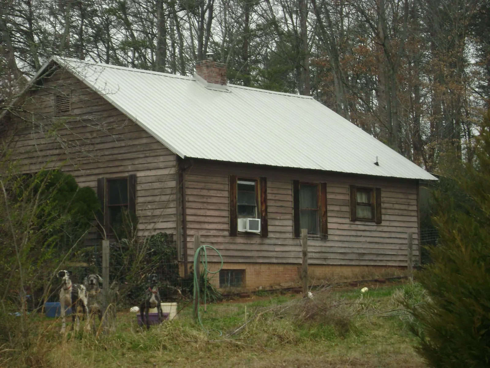 White metal roof on an old wood sided farmhouse, from a Metal Roof Installation job in Shamokin